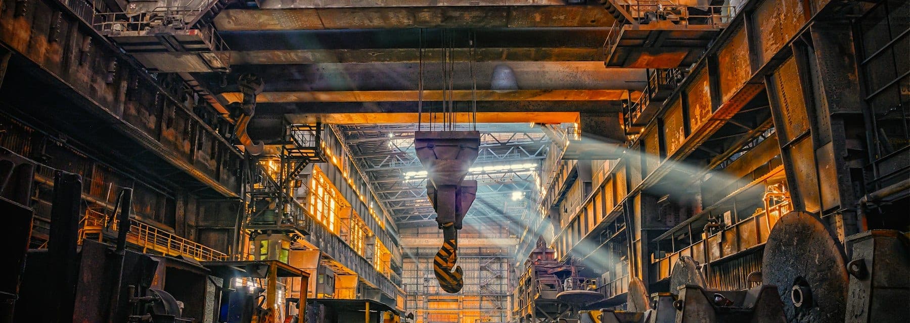 A heavy industrial hall with an overhead gantry crane above the production floor.
